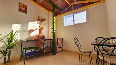 a room with a table and chairs and a window at Cyndi Home Gueliz \u72ec\u4eab\u6574\u5957\u516c\u5bd3 in Marrakech