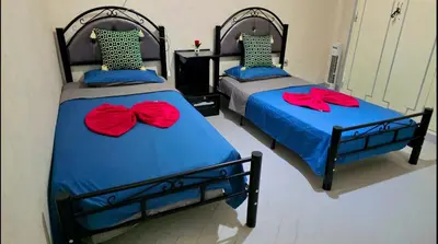 two beds with red bows on them in a bedroom at Cyndi Home Gueliz \u72ec\u4eab\u6574\u5957\u516c\u5bd3 in Marrakech