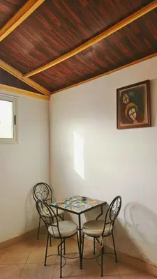 a table and two chairs in a room at Cyndi Home Gueliz \u72ec\u4eab\u6574\u5957\u516c\u5bd3 in Marrakech