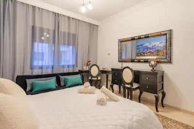 a bedroom with a bed and a desk and a mirror at Amazing apartment in the heart of Marrakesh in Marrakech