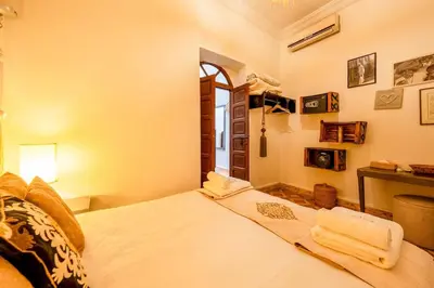 a bedroom with a large white bed with towels on it at Riad 3 chambres - petit déjeuner gratuit - Top position in Marrakech