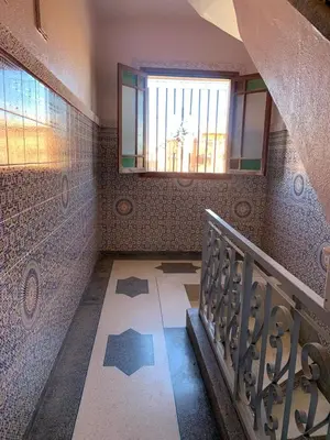 a staircase in a house with a window and a stair case at Apparemment Aglmous in Marrakech