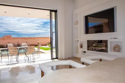 a living room with a view of a patio at Villa Palmeraie 4 suites zéro vis à vis in Marrakech