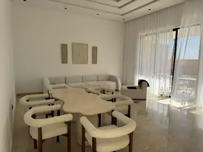 a dining room with a table and some chairs at Villa Palmeraie 4 suites zéro vis à vis in Marrakech