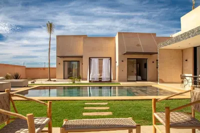 a house with a swimming pool in the yard at Villa Palmeraie 4 suites zéro vis à vis in Marrakech
