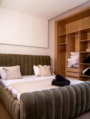 a large bed in a room with a large couch at Villa Palmeraie 4 suites zéro vis à vis in Marrakech
