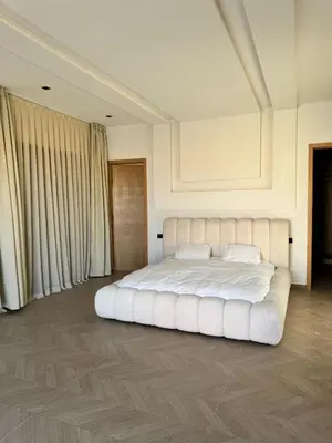 a bedroom with a large white bed with white pillows at Villa Palmeraie 4 suites zéro vis à vis in Marrakech