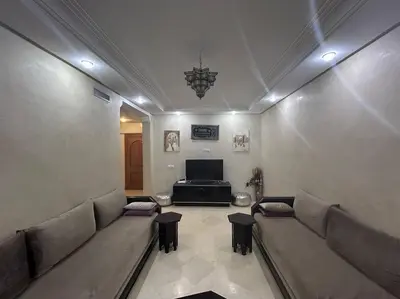 a waiting room with couches and a flat screen tv at Ruime 2 kamer appartement 5 min van het centrum in Marrakech