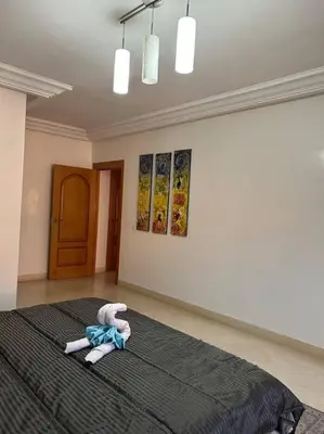 a bedroom with a bed with a stuffed animal on it at Ruime 2 kamer appartement 5 min van het centrum in Marrakech