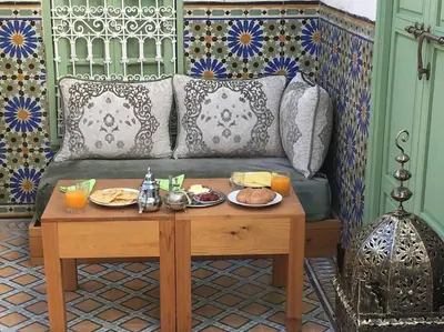 a table with plates of food on top of a couch at Riad Charij in Marrakech