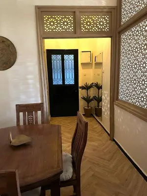a dining room with a table and chairs and a door at Soleil de Medina in Marrakech
