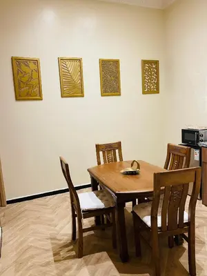 a dining room with a wooden table and chairs at Soleil de Medina in Marrakech
