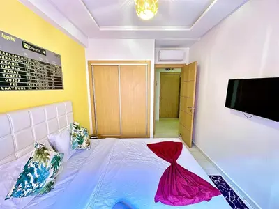 a bedroom with a bed and a flat screen tv at Apparemment in marrakech in Marrakech