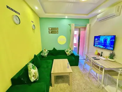 a living room with a green couch and a table at Apparemment in marrakech in Marrakech