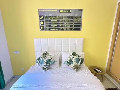 a bed with two pillows and a calender on the wall at Apparemment in marrakech in Marrakech