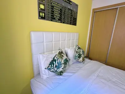 a bed with two pillows and a scoreboard on the wall at Apparemment in marrakech in Marrakech