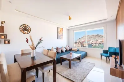 a living room with a blue couch and a table at Chic 2 Bedroom with Mountain views Gueliz in Marrakech