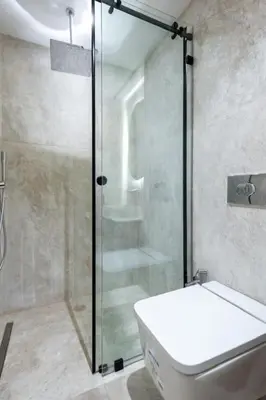 a bathroom with a glass shower and a toilet at Chic 2 Bedroom with Mountain views Gueliz in Marrakech
