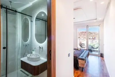 a bathroom with a sink and a glass shower at Luxury 2 Bedroom with Mountain View in Marrakech
