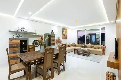a living room with a table and a couch at Luxury 2 Bedroom with Mountain View in Marrakech