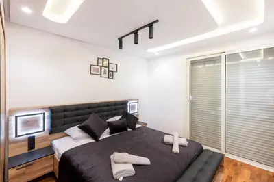 a bedroom with a large bed with two towels on it at Luxury 2 Bedroom with Mountain View in Marrakech