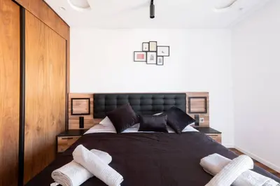 a bedroom with a black bed with two white socks at Luxury 2 Bedroom with Mountain View in Marrakech