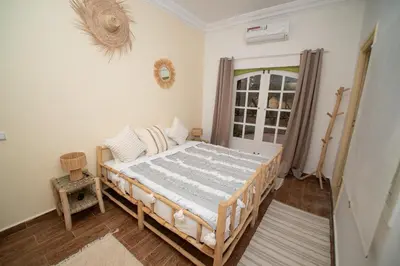 a bedroom with a bed and a window at La Villa Safran Ailleurs sous les Oliviers in Marrakech