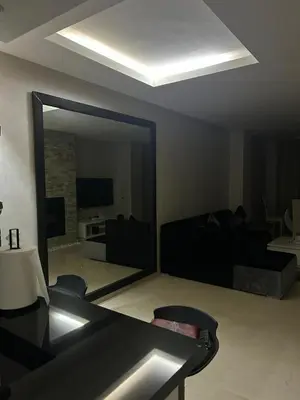 a living room with a large mirror and a couch at Prestigia corail in Marrakech
