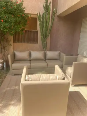 a living room with a couch and a table at Prestigia corail in Marrakech