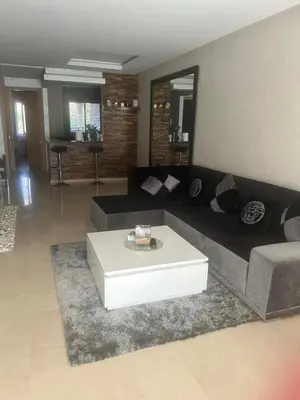 a living room with a couch and a coffee table at Prestigia corail in Marrakech