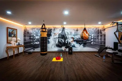 a room with a gym with boxing equipment on the wall at Villa Saphia K in Marrakech