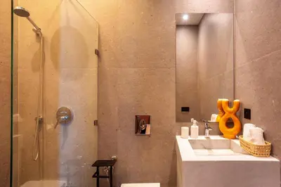a bathroom with a shower with a sink and a glass shower door at Villa Saphia K in Marrakech