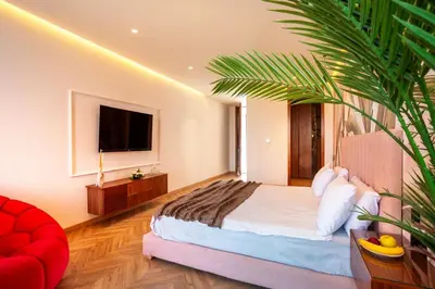 a bedroom with a bed and a tv and a plant at Villa Saphia K in Marrakech