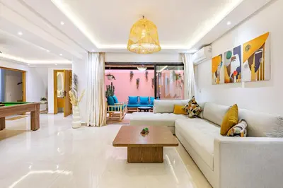 a living room with a couch and a pool table at Verdelune Apartments in Marrakech