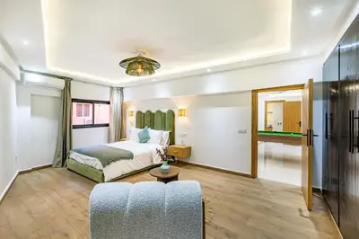a hotel room with a bed and a couch at Verdelune Apartments in Marrakech