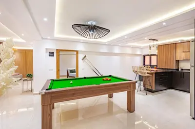 a pool table in a living room with at Verdelune Apartments in Marrakech