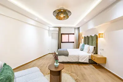 a bedroom with a bed and a couch at Verdelune Apartments in Marrakech