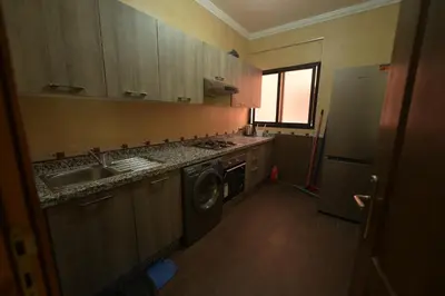 a kitchen with a sink and a washing machine at Carisia Liam in Marrakech