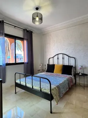 a bedroom with a bed in a room at Appartement Sylia in Marrakech