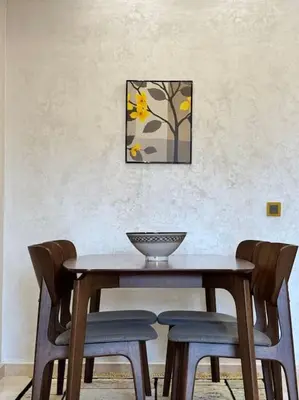 a dining room table with chairs and a bowl on it at Appartement Sylia in Marrakech