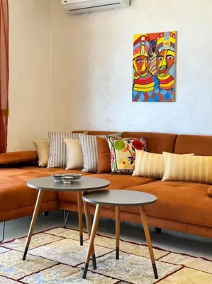 a living room with a couch and two tables at Appartement Sylia in Marrakech