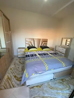 a bedroom with a bed with a blue comforter at Apparemment in Marrakech
