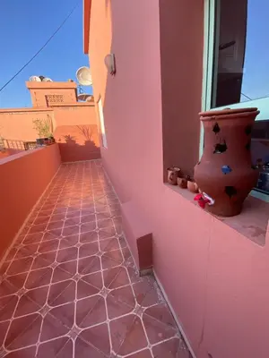 a balcony with a vase sitting on a window sill at Apparemment in Marrakech