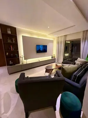 a living room with two couches and a flat screen tv at Prestigia Marrakech golf city appartement 3 chambre in Marrakech