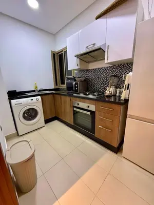 a kitchen with a washing machine and a washer at Prestigia Marrakech golf city appartement 3 chambre in Marrakech