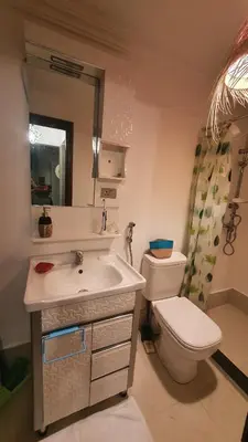 a bathroom with a sink and a toilet and a mirror at Appartement T3 Le petit chat in Marrakech