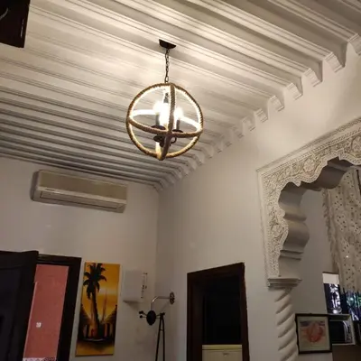 a chandelier hanging from a ceiling in a room at Appartement T3 Le petit chat in Marrakech