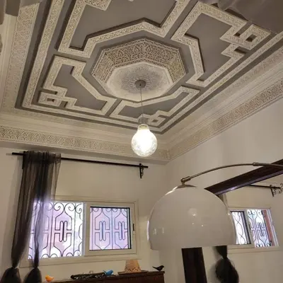 a room with a coffered ceiling and a light fixture at Appartement T3 Le petit chat in Marrakech