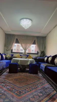 a living room with two beds and a large rug at HOURIA LOC Marrakech in Marrakech