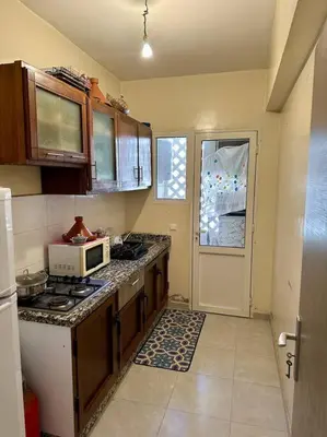 a kitchen with a stove and a microwave at 2B Flat City Center Marrakech in Marrakech